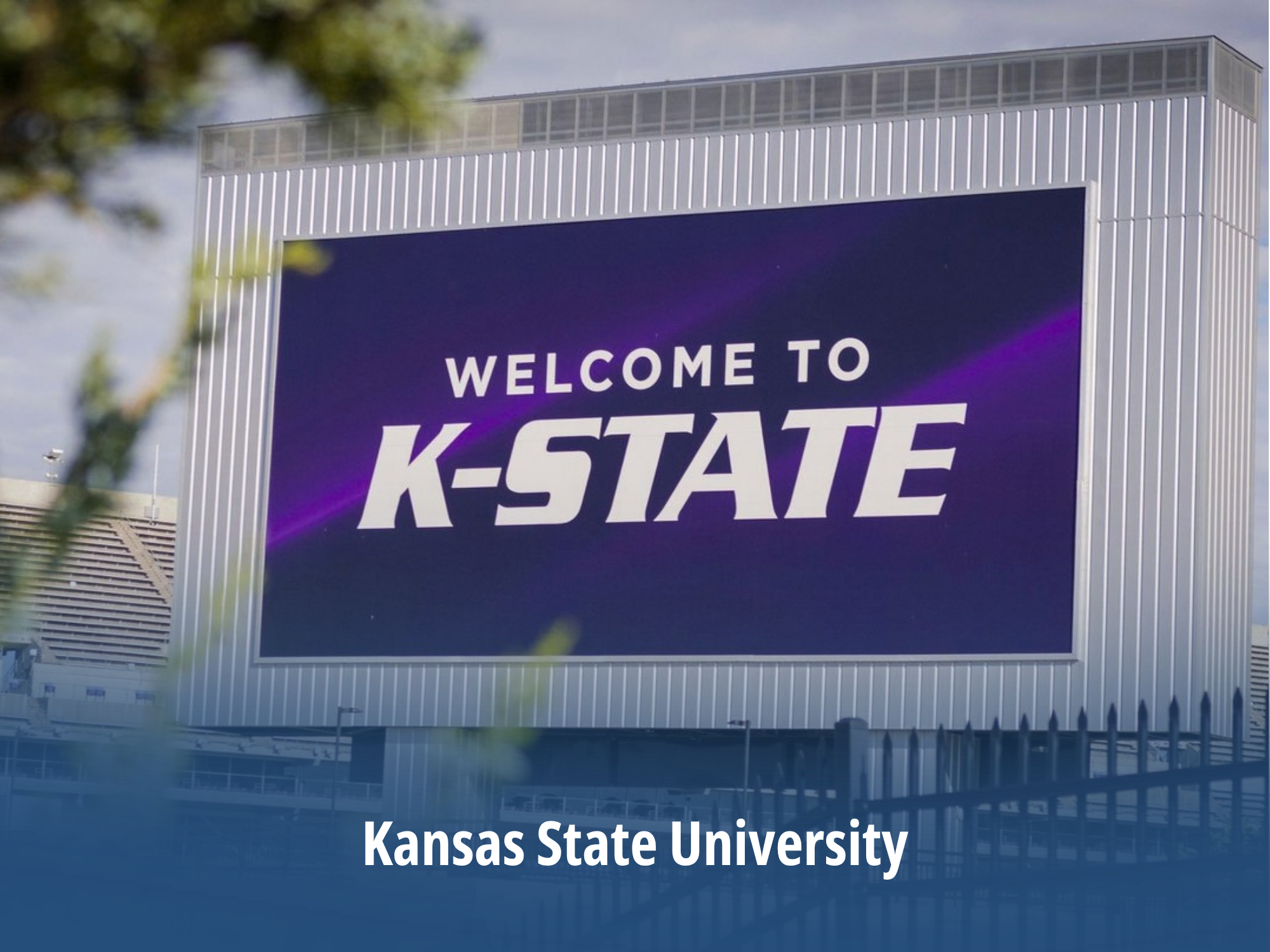 A large billboard near a stadium displays the words 